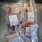 Vacuum-sealed packages of raw meat on a metallic surface